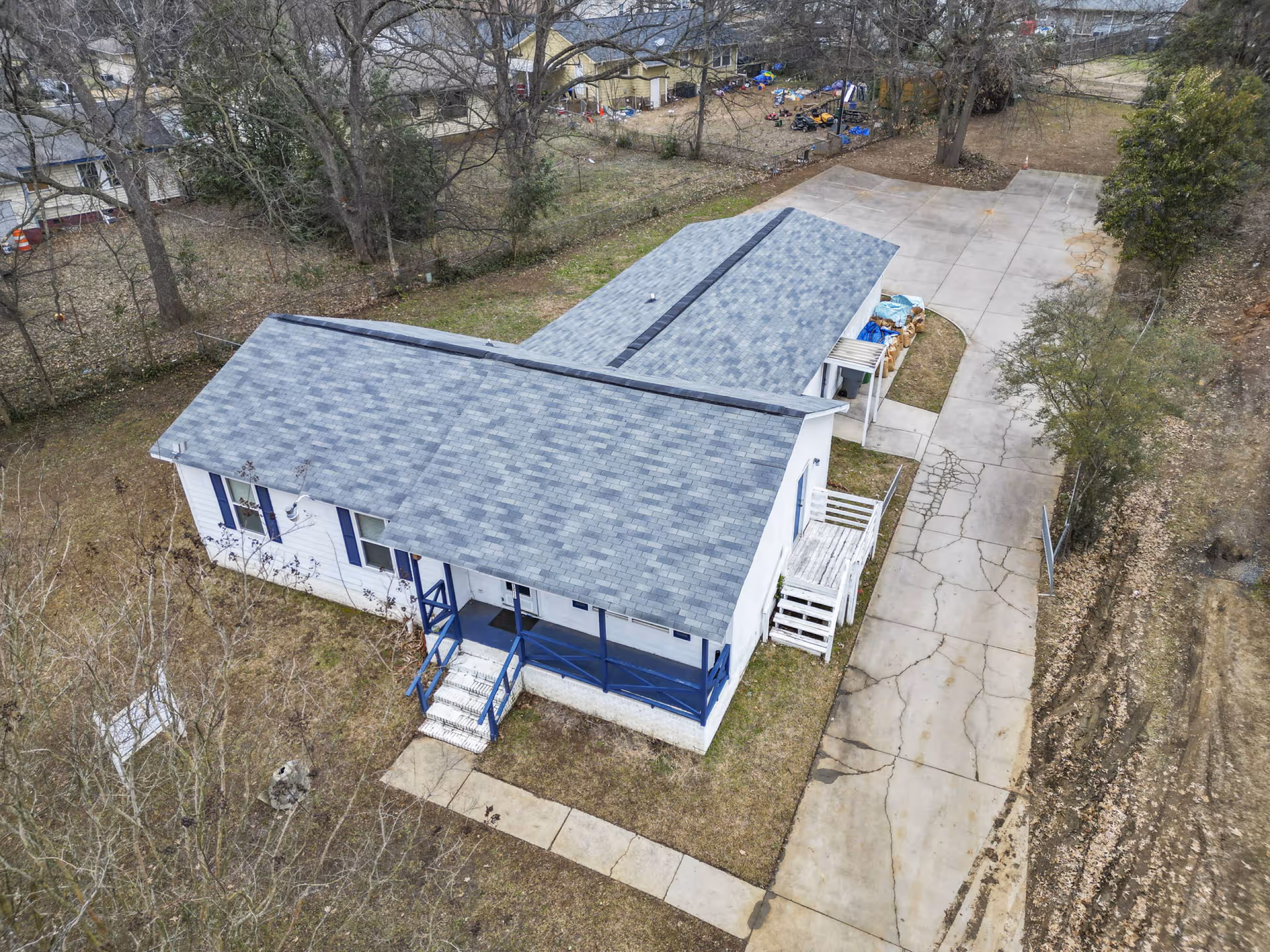Aerial view of a single-story senior care facility with blue porch railing and driveway.