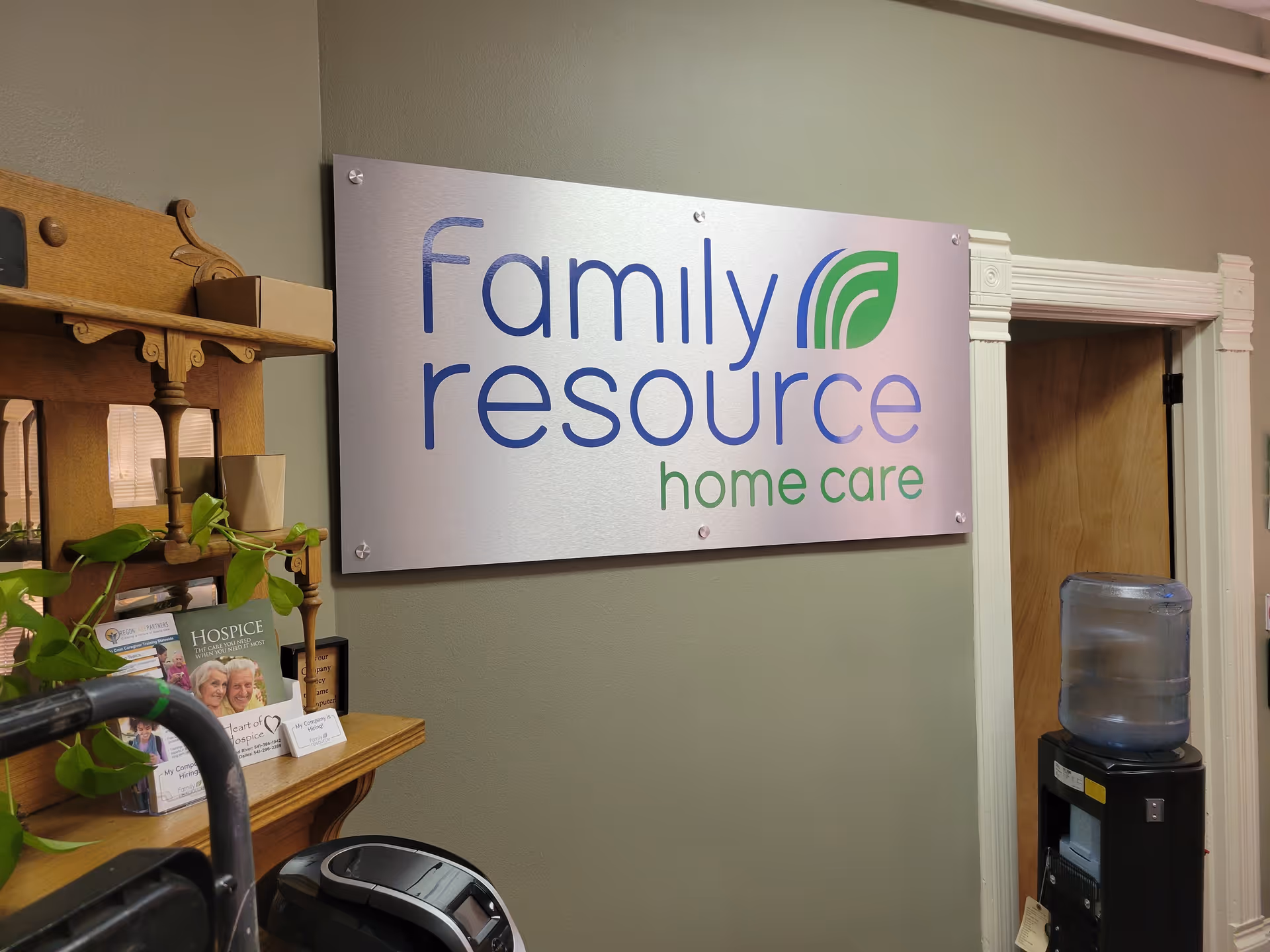 Indoor reception area featuring a large Family Resource Home Care sign on the wall.