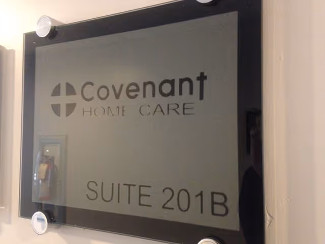 Framed wall sign reading Covenant Home Care Suite 201B