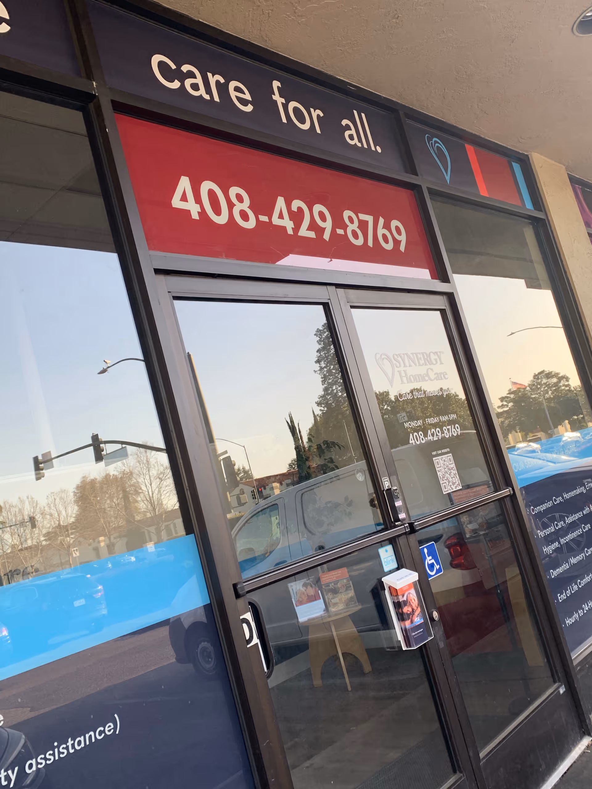 Front entrance of a SYNERGY HomeCare facility with glass doors and signage.
