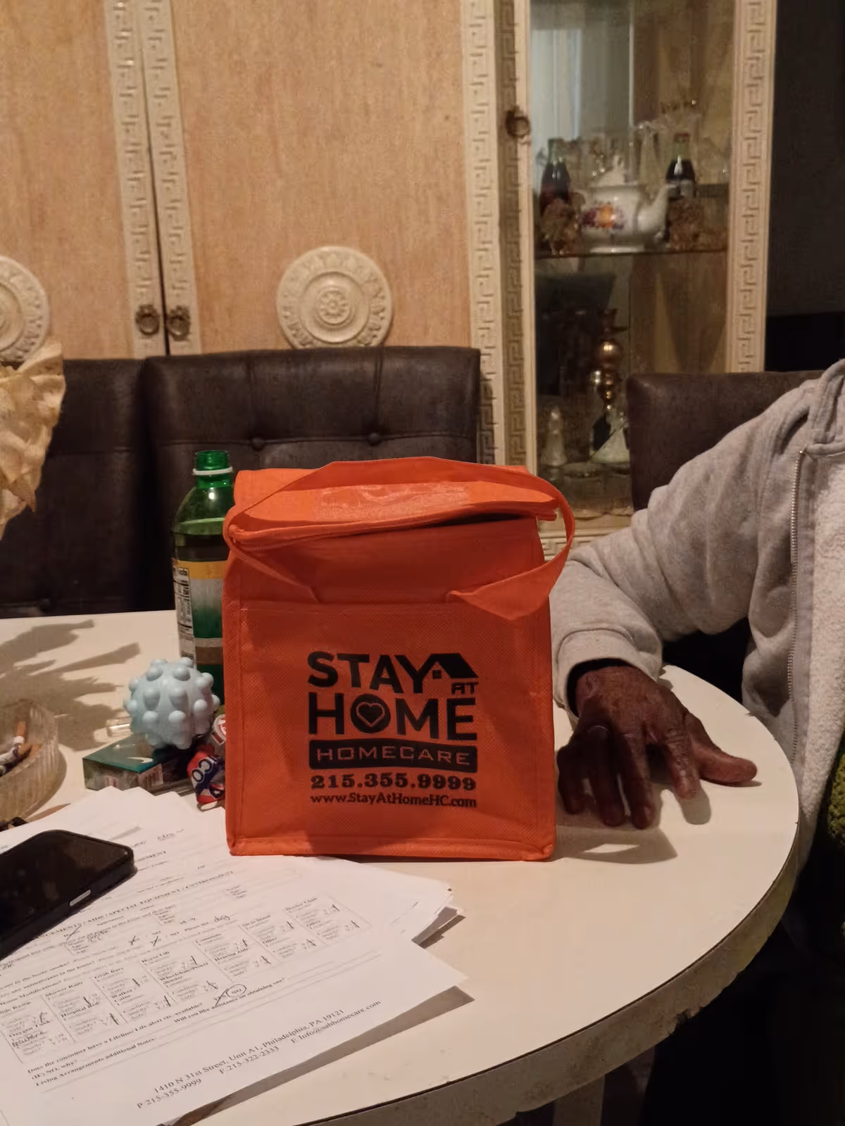 Orange Stay At Home Homecare bag on a round dining table indoors