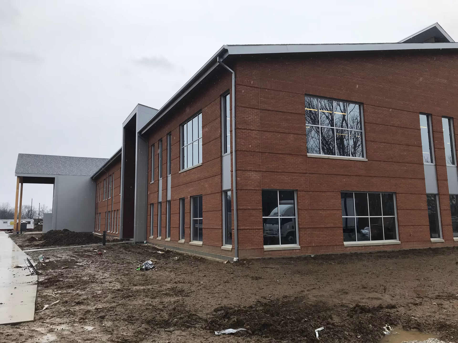Exterior view of Absolute Health Services facility under construction with brick walls and large windows.