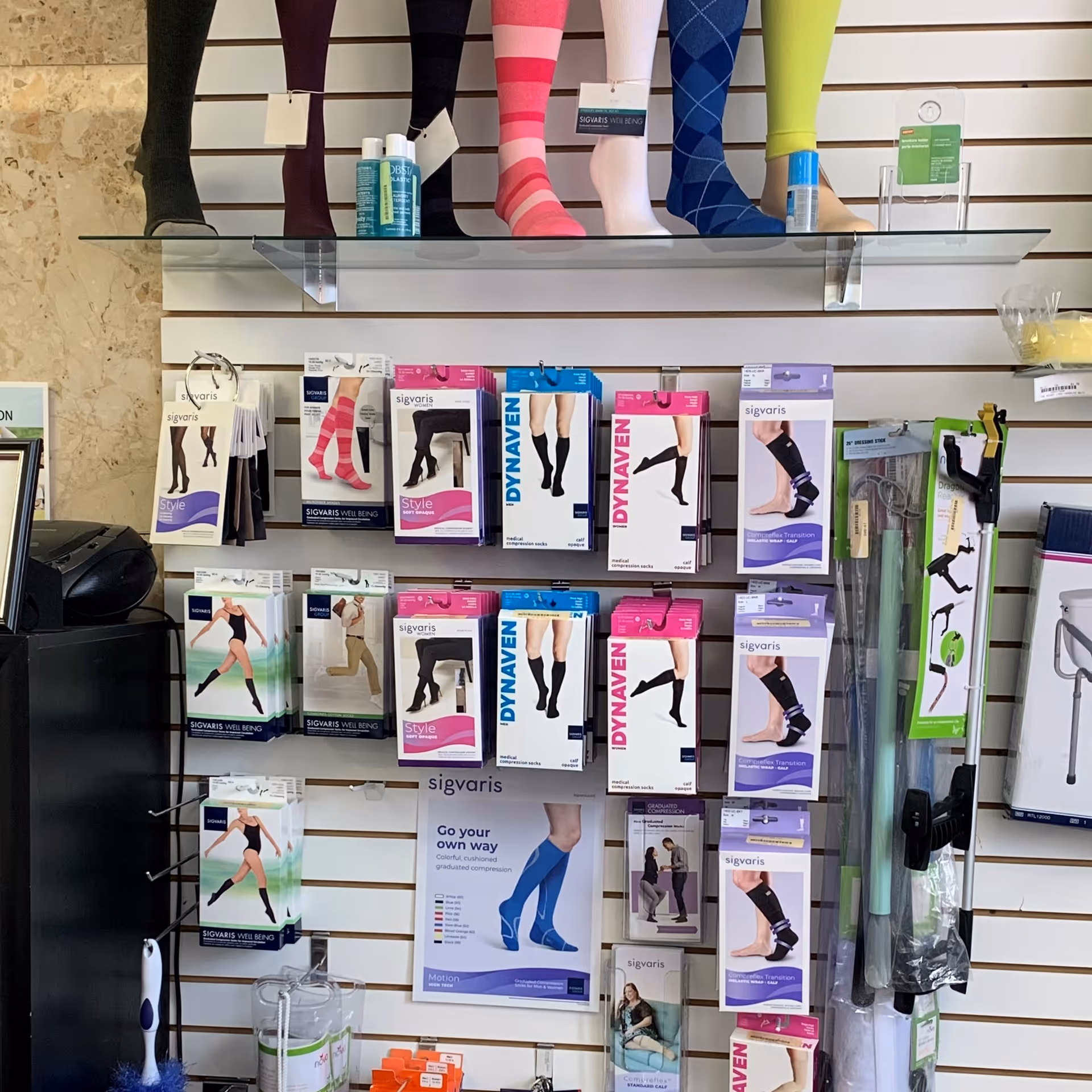 Colorful hosiery and compression stockings displayed on wall racks.