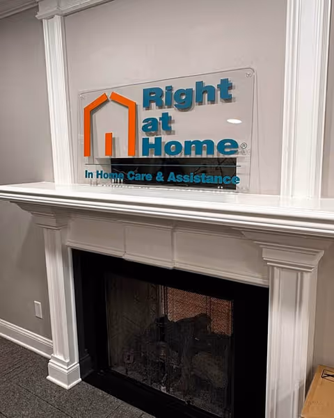 Interior fireplace mantel with Right at Home sign above in-home care lobby
