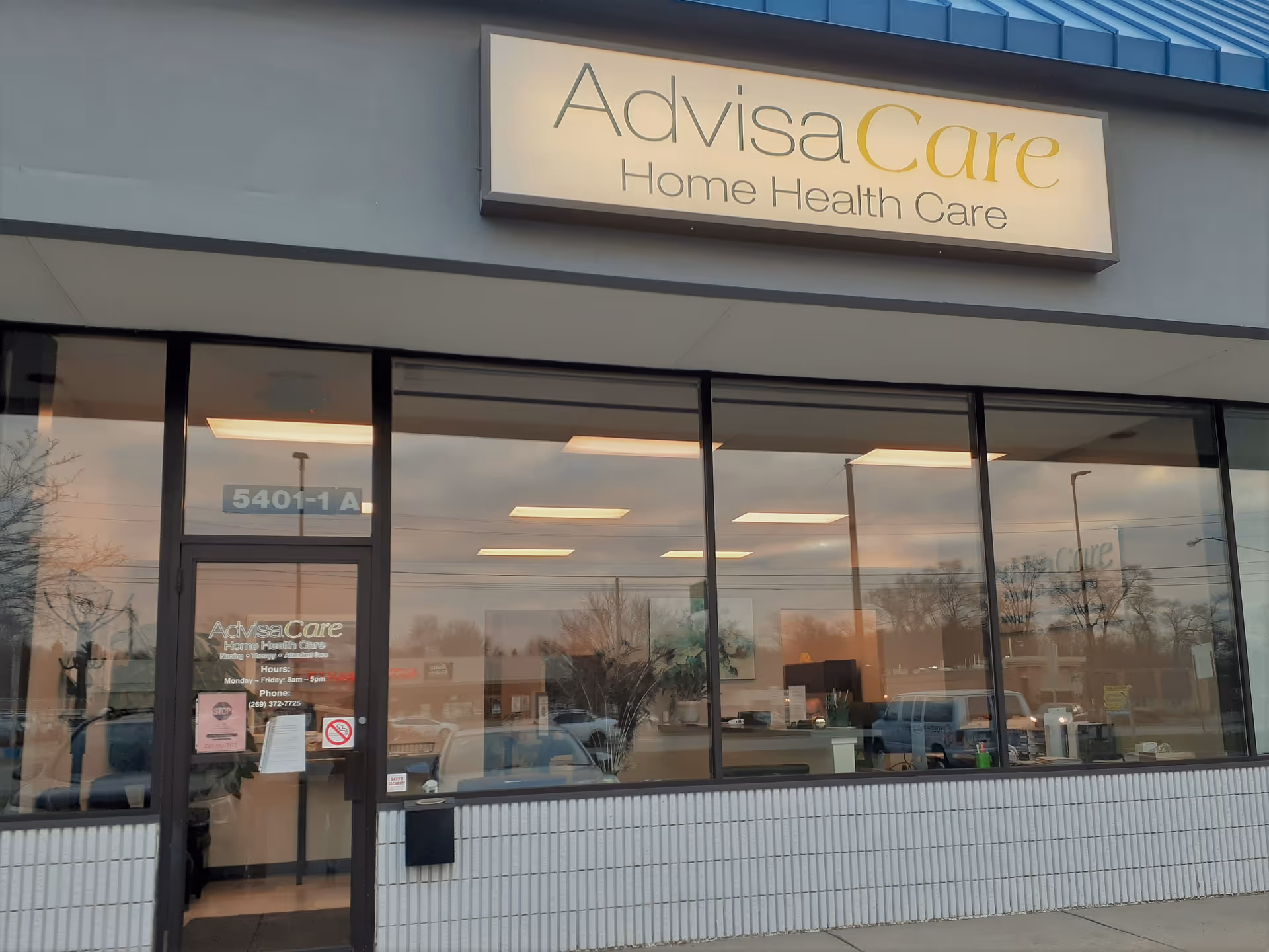 Exterior view of AdvisaCare storefront with large glass windows and a sign above the entrance.