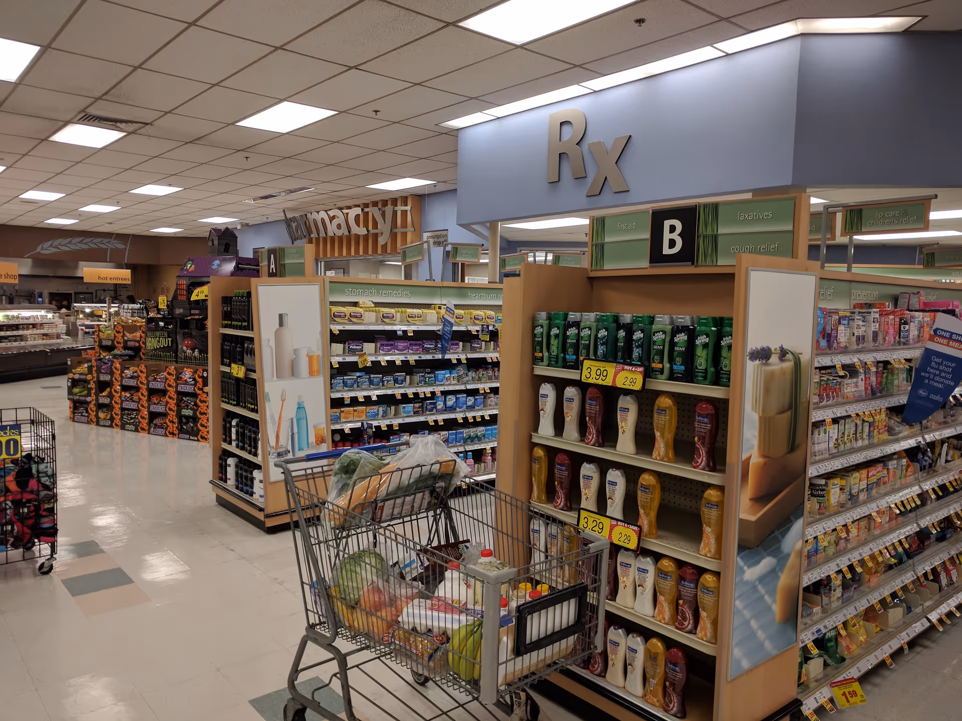 Interior view of a Kroger Pharmacy with aisles, shopping carts, and displays.