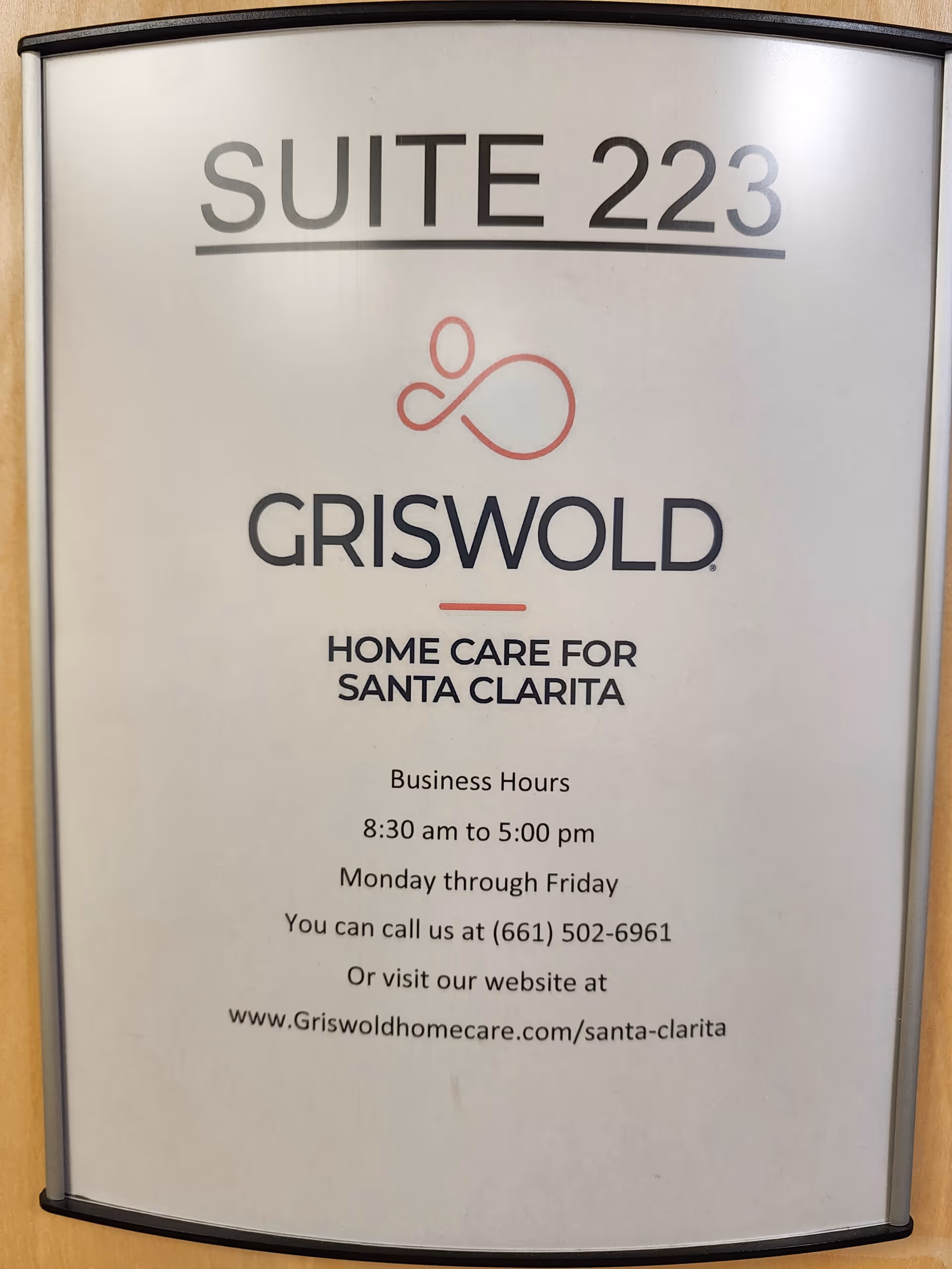 Indoor sign for Griswold Home Care Santa Clarita with suite number.