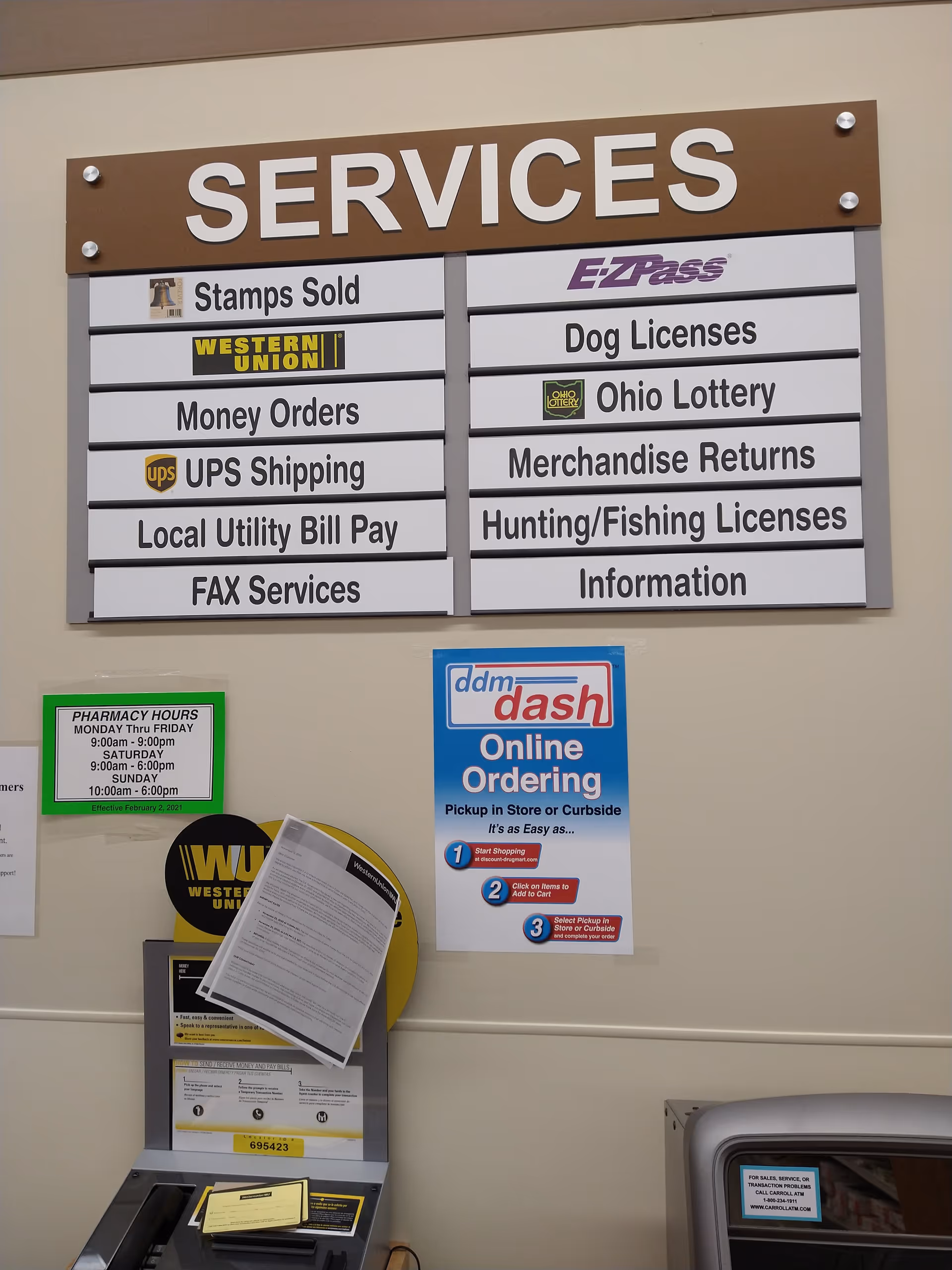 Interior wall with a large SERVICES sign and various listed services at Discount Drug Mart.