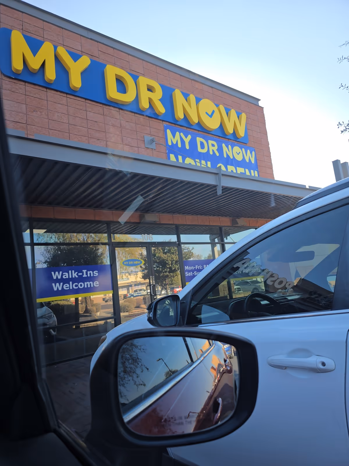 Exterior view of MY DR NOW facility with large yellow sign.