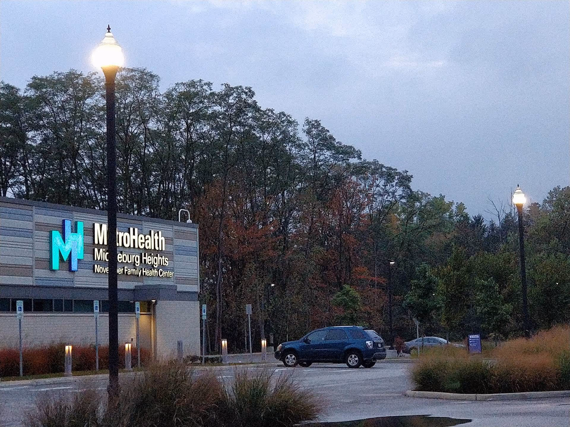 Exterior view of MetroHealth Middleburg Heights Family Health Center with parking and trees.