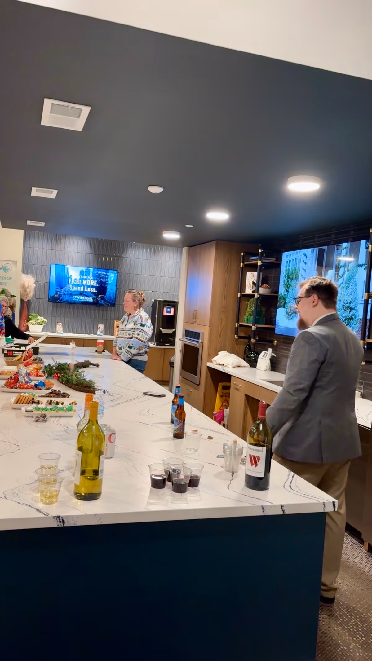 Modern kitchen island in a senior home care facility with guests and beverages.