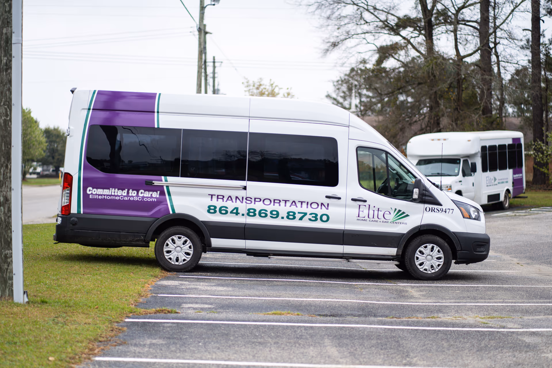 White Elite Home Care Transportation van parked in a lot.