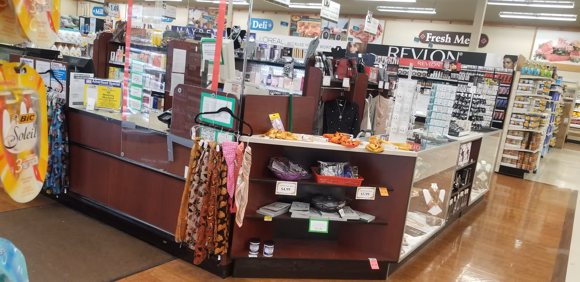 Interior of a discount drug store with a checkout counter and cosmetics displays.