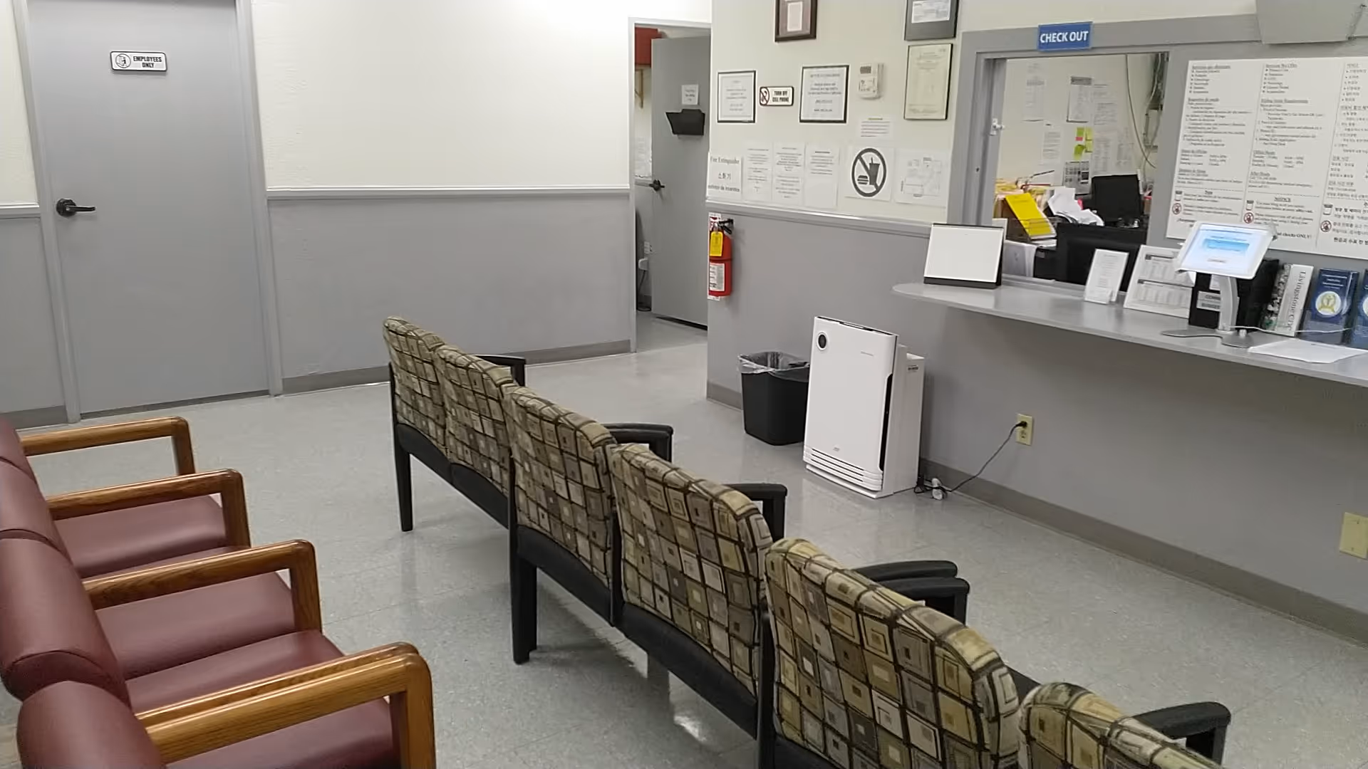 Interior waiting area of Livingstone CDC with row seating, a reception desk, and posted notices.