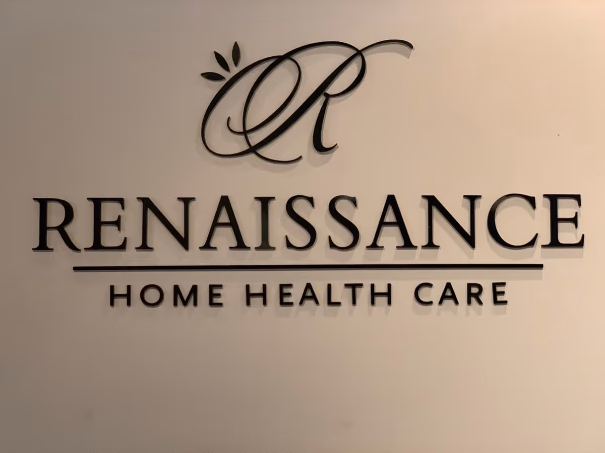 Wall sign reading Renaissance Home Health Care on beige interior wall