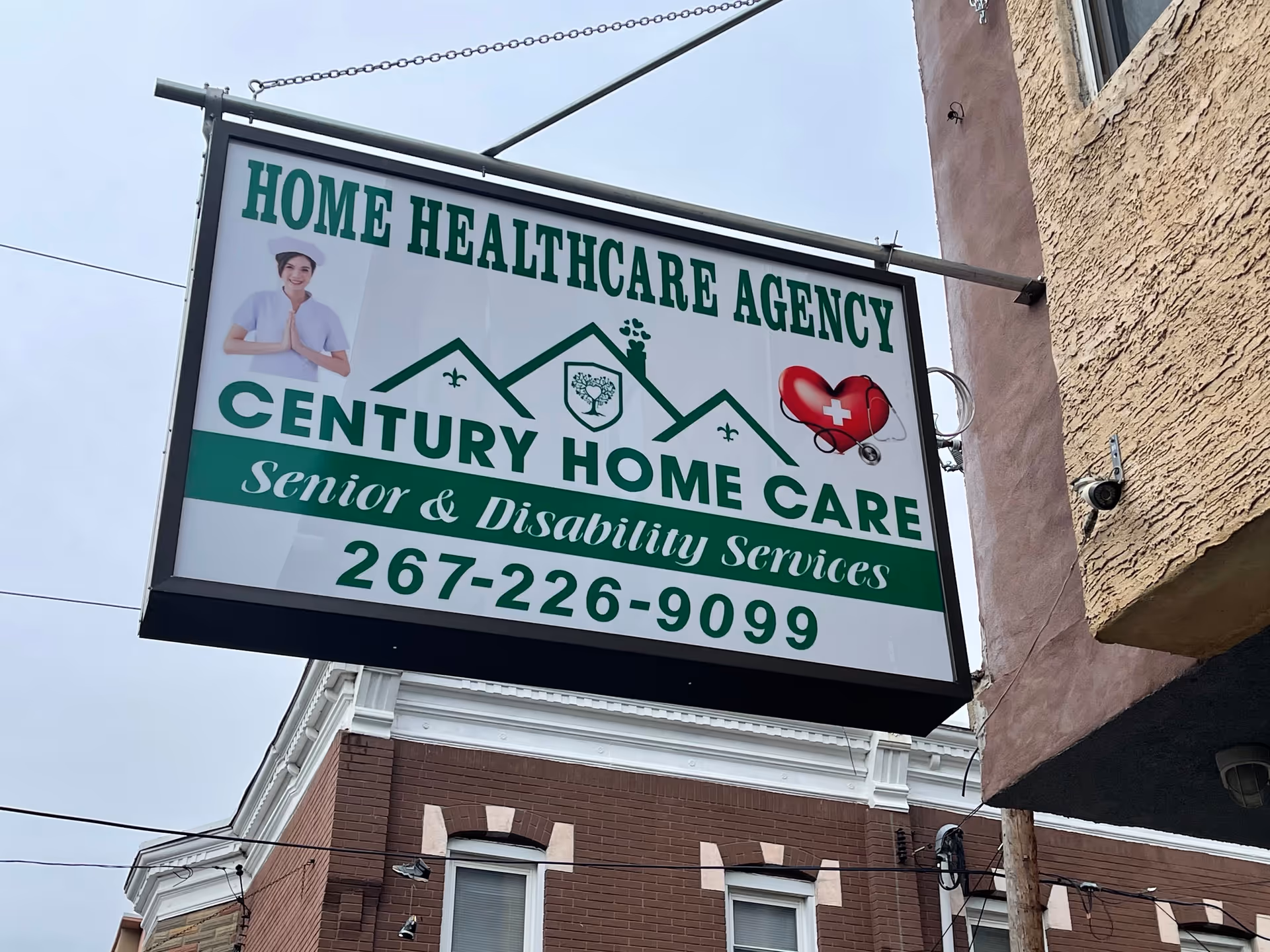 Exterior view of Century Home Care sign hanging on a brick building