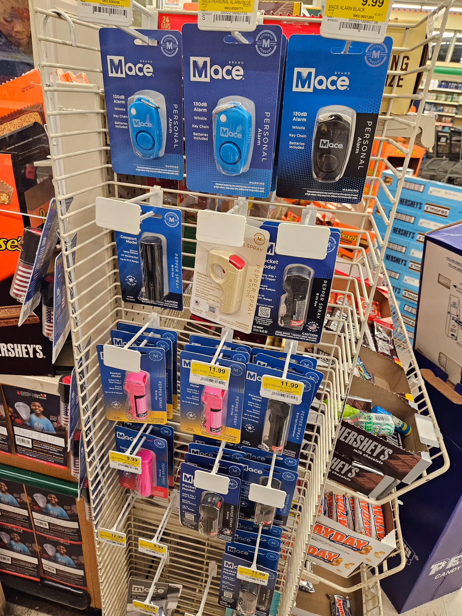 Rack of Mace personal safety devices on a store display