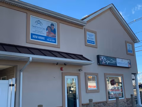 Exterior of a beige building with Best Home Care Inc signage and a dental clinic sign.