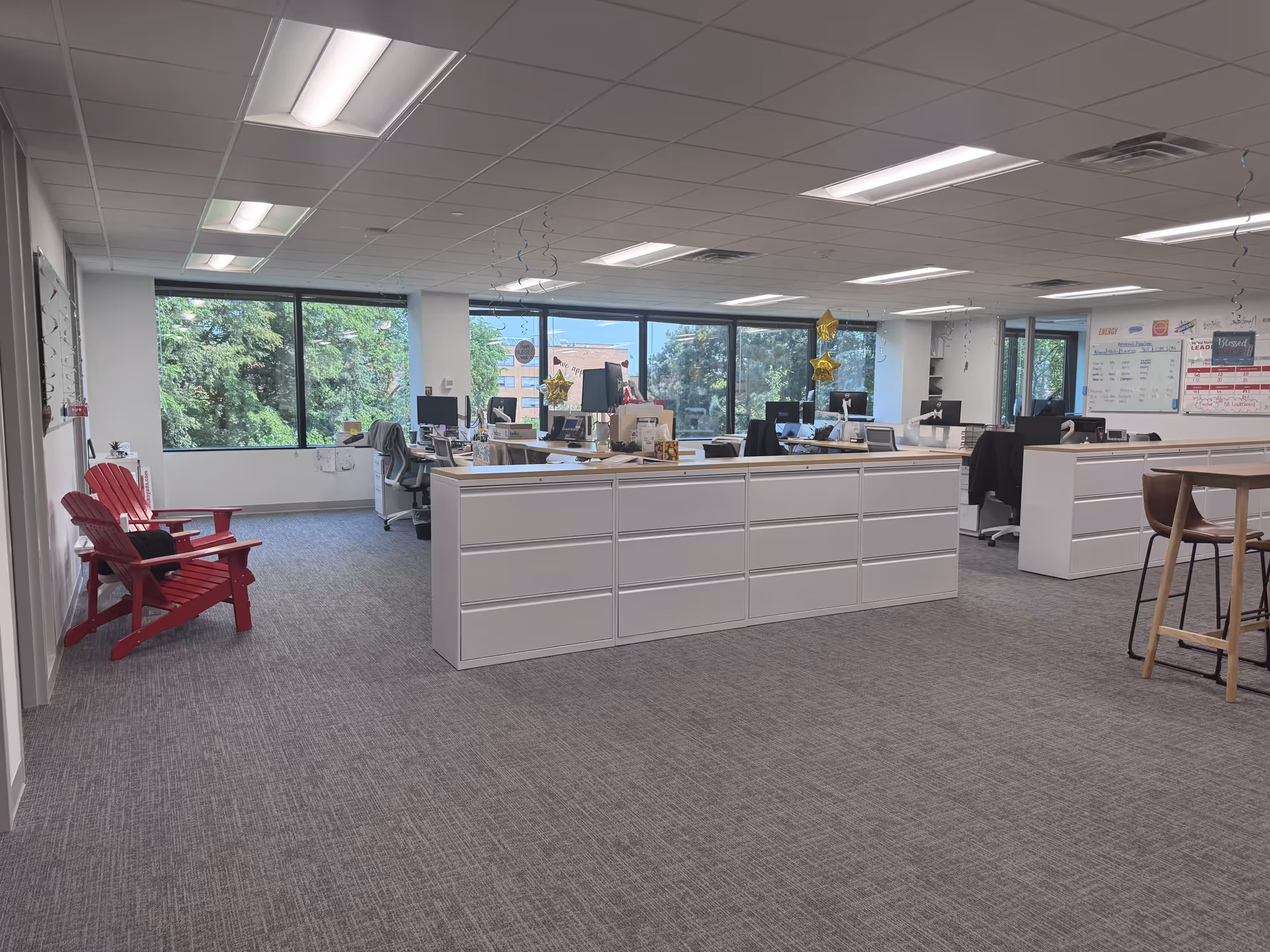 Open office area with cubicles, computers, and windows in a BAYADA nursing facility.