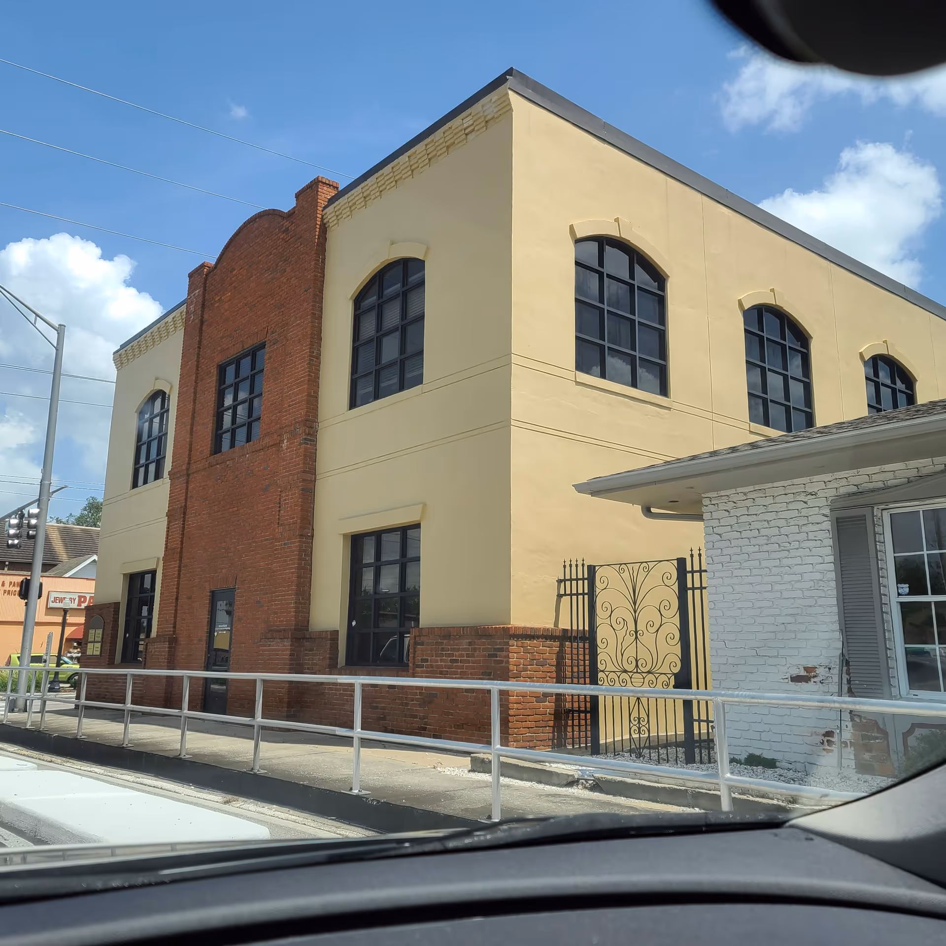 Exterior view of a Comfort Keepers building with yellow walls and brick center.