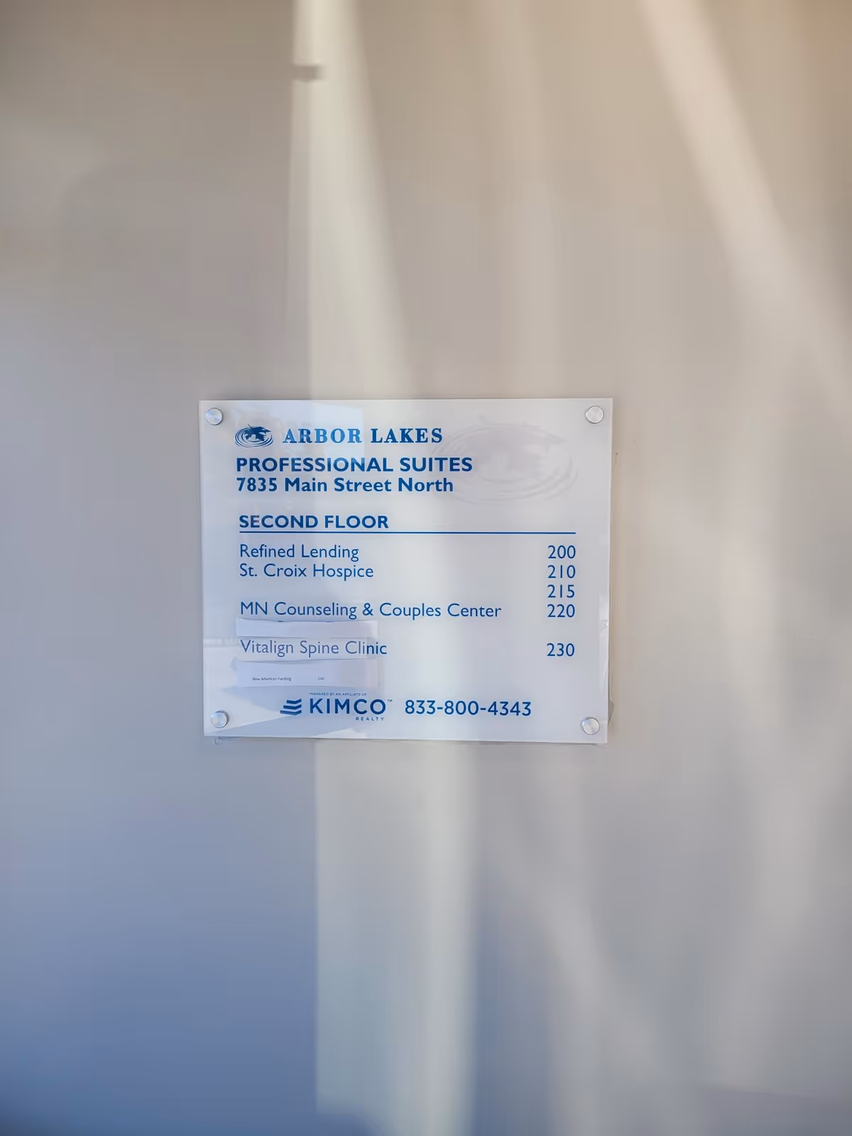 Indoor wall sign listing suites and tenants on the building's second floor.