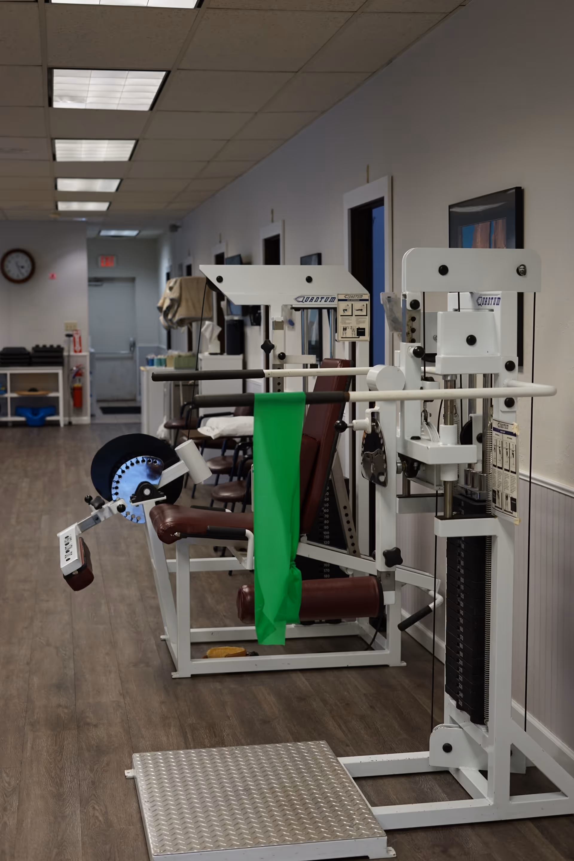 Indoor physical therapy gym with weight machines and exercise equipment.