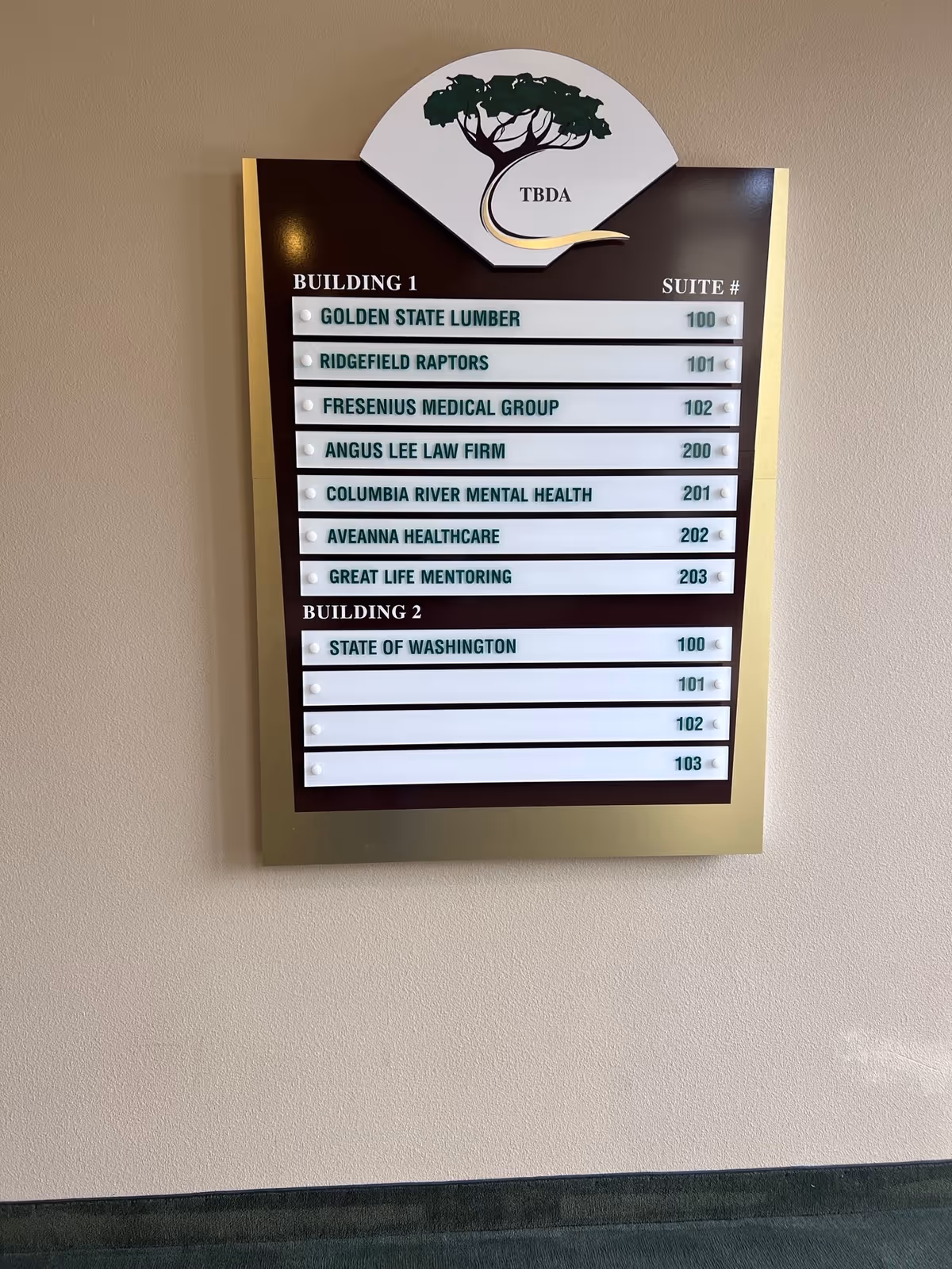 Interior hallway directory sign listing Building 1 and Building 2 tenants, including Aveanna Healthcare.