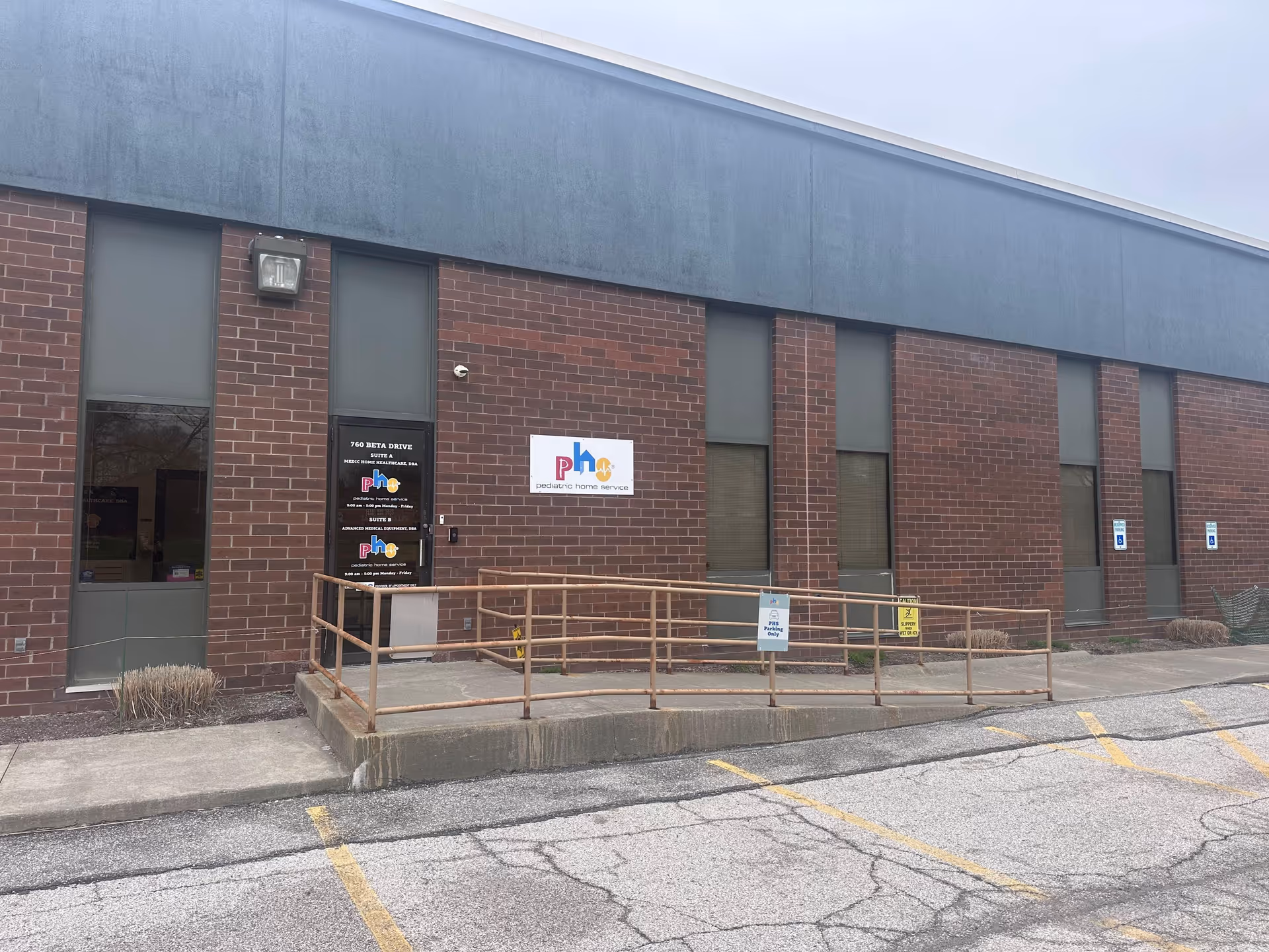Brick exterior of Pediatric Home Service facility with a ramped entrance.