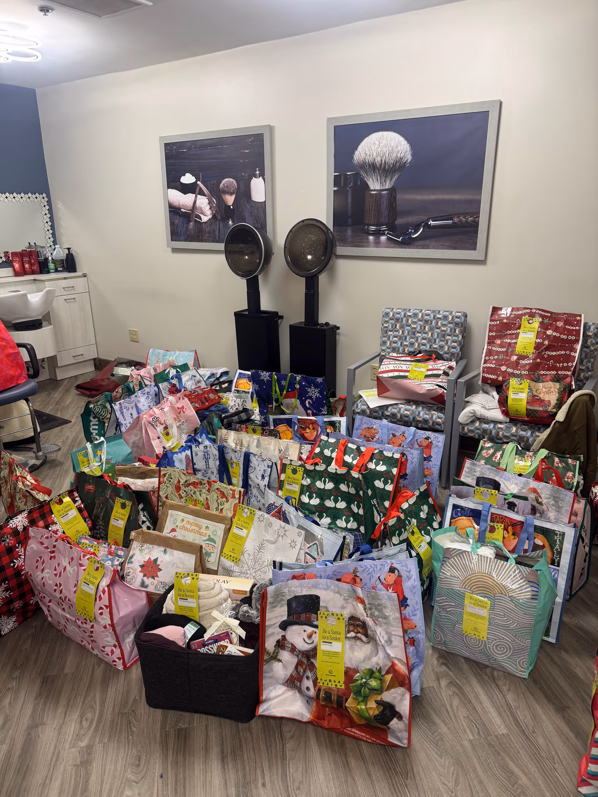 Interior senior facility room with numerous wrapped gift bags on floor and salon equipment.