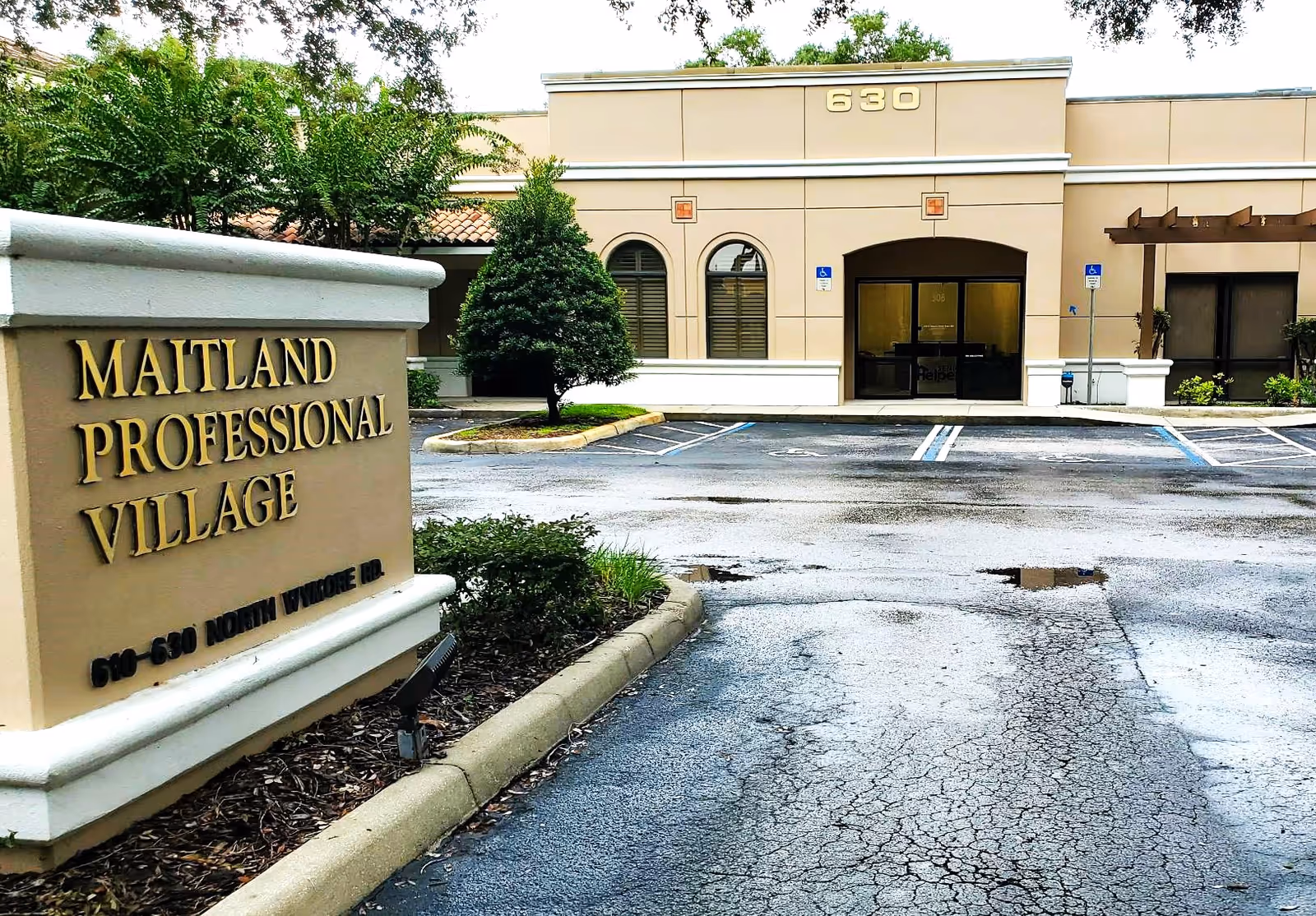 Exterior view of a senior living facility entrance with Maitland Professional Village sign