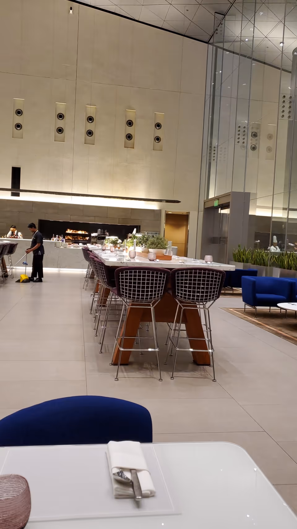Modern dining area inside Sahara Home Care with long tables and high chairs