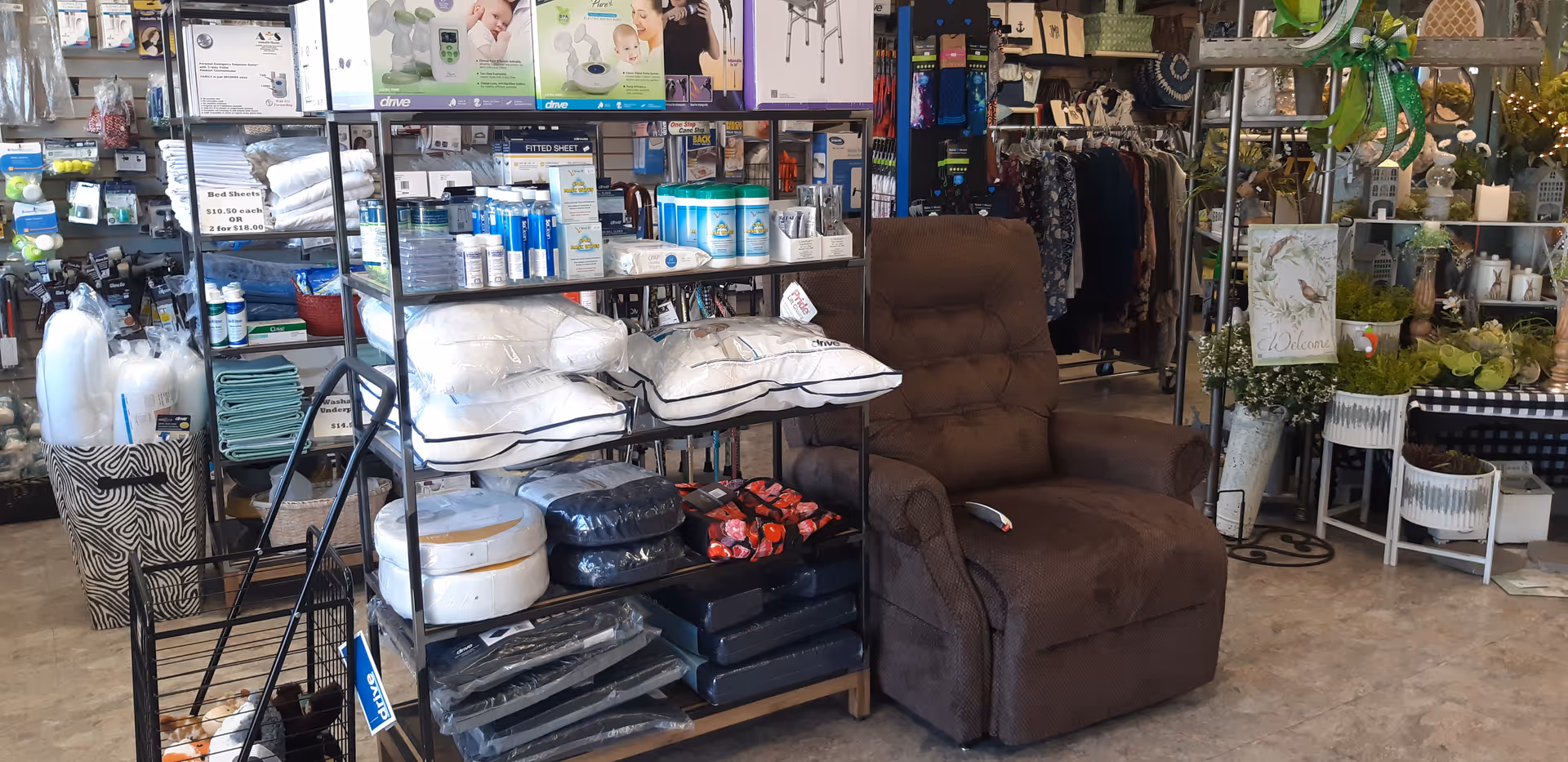Brown recliner beside shelves of pillows and home accessories in a store showroom