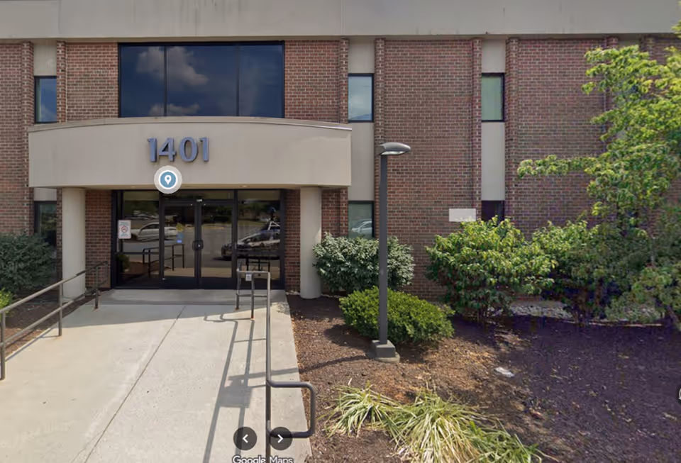 Front entrance of a BrightStar Care building with glass doors and brick exterior.