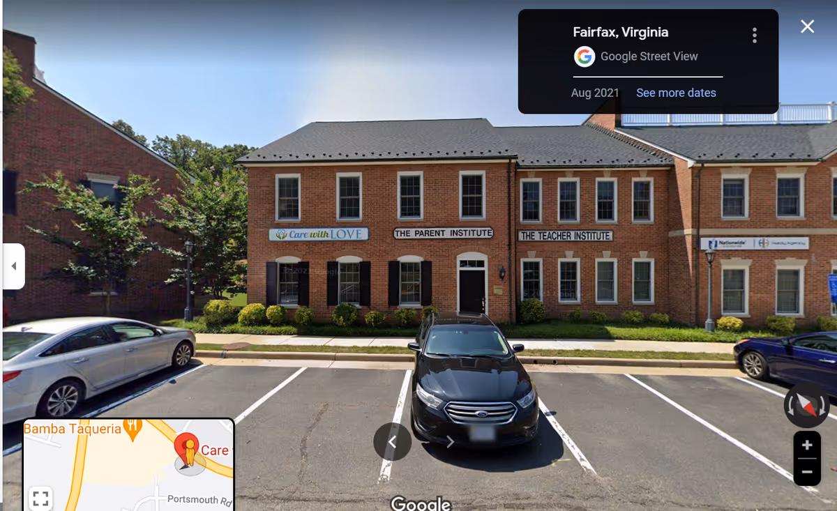 Brick senior living facility with front entrance, signage, and parked cars along the curb.