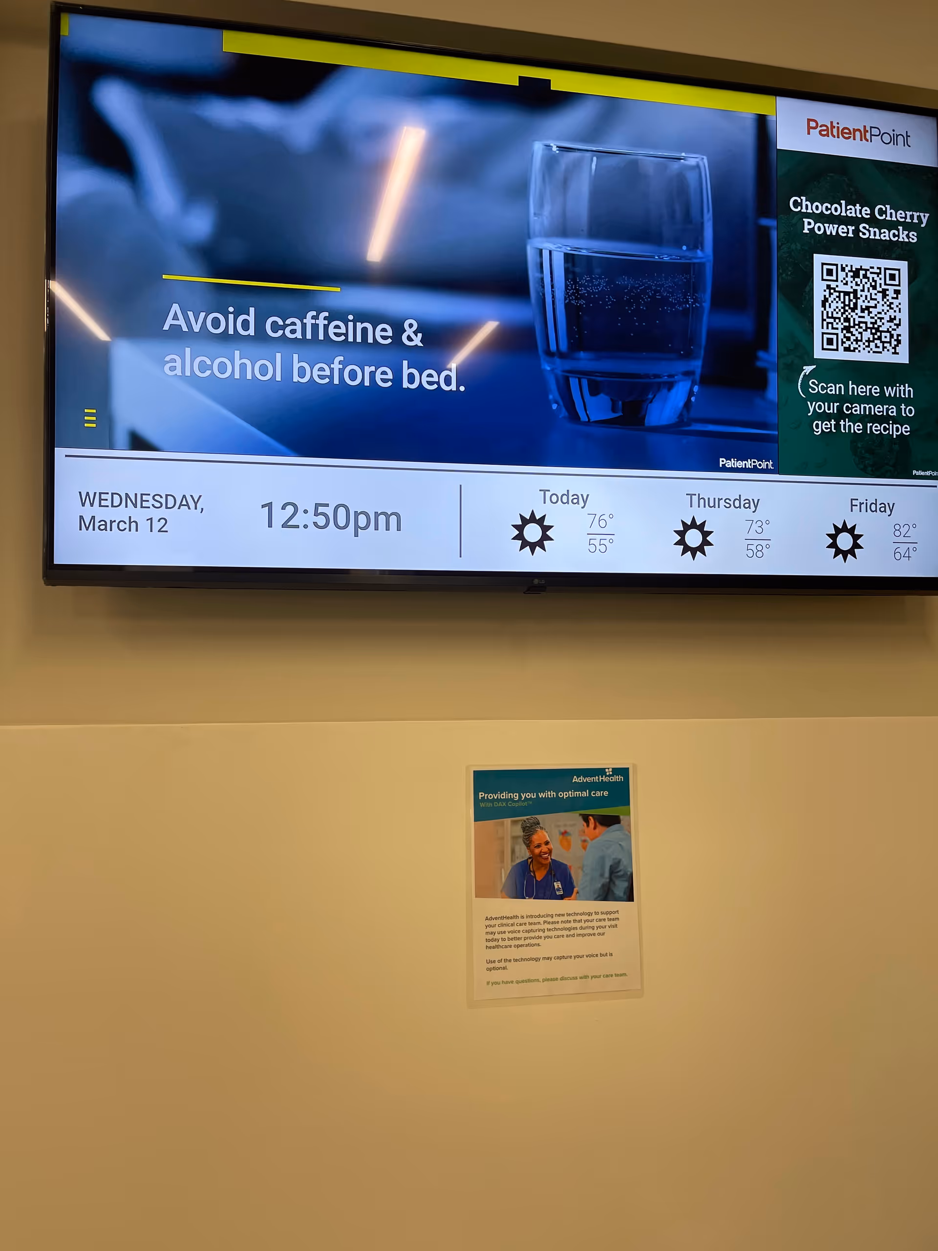 Large wall-mounted screen shows caffeine warning with weather timeline; small poster below.