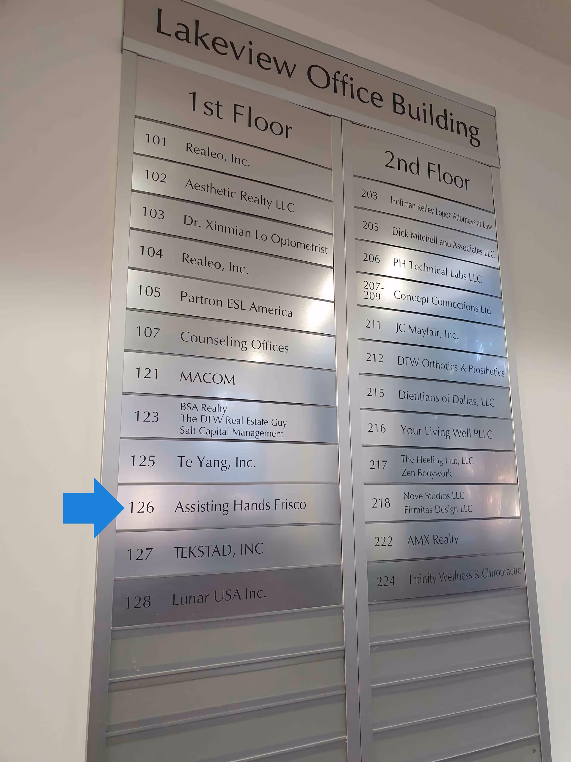 Indoor directory board listing tenants on two floors, including Assisting Hands Frisco.