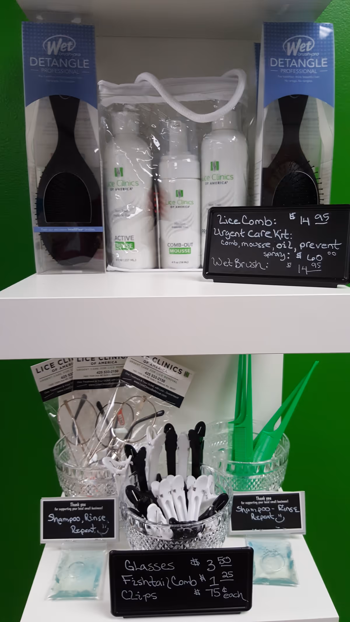 Lice treatment products and combs arranged on white shelves in a bright display.