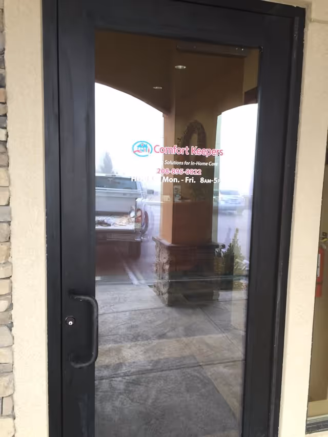 Glass entrance door displaying the Comfort Keepers sign at the building front.