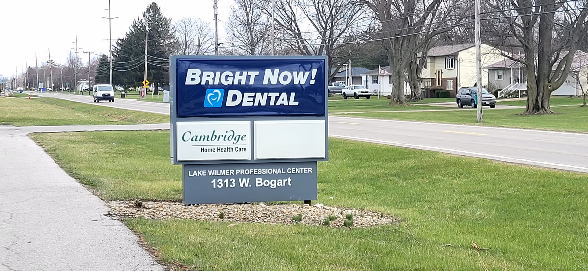 Outdoor street sign promoting Cambridge Home Health Care and Bright Now Dental