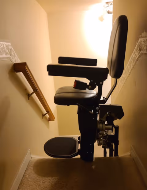 Interior stairwell with a mounted wheelchair stairlift in a facility.