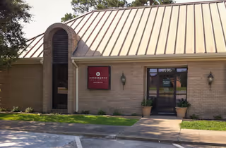 Exterior view of a single-story brick building with Enhabit Home Health sign and entrance.