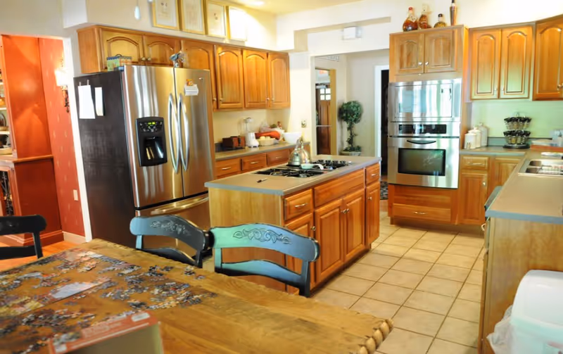 Kitchen in Good Samaritan Hospice House in Wexford with island and stainless appliances.