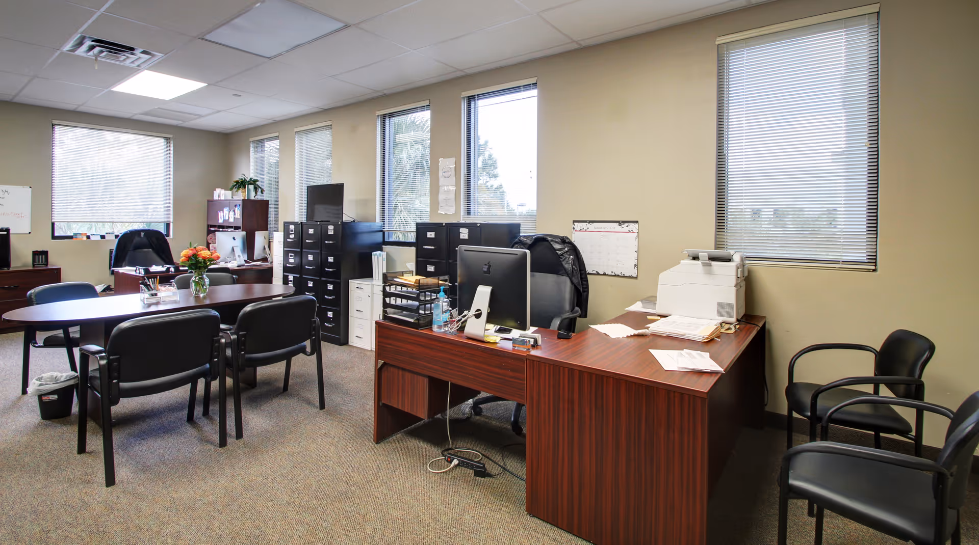 Office-like staff workspace in a senior living facility with desks and chairs.