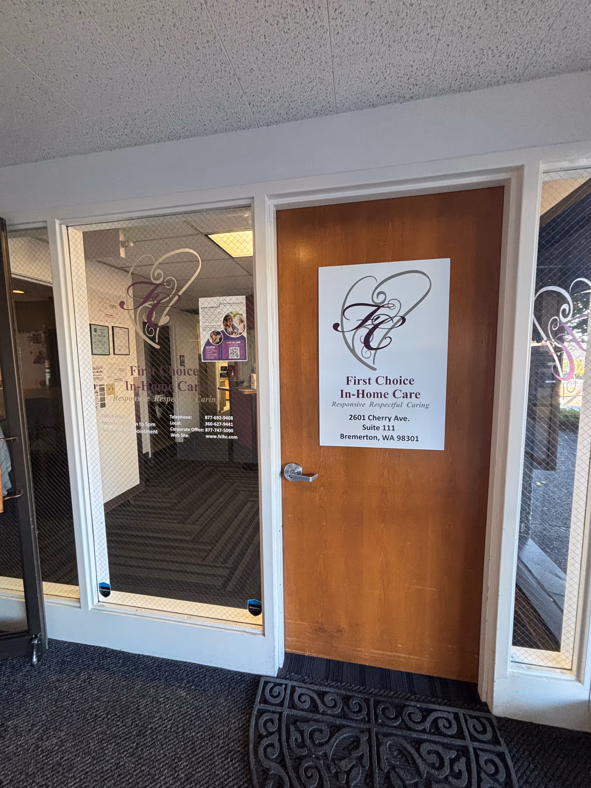 Wooden door with First Choice In-Home Care sign beside glass entry panels.