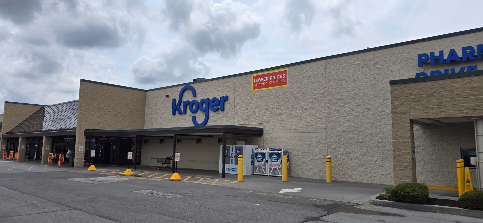 Exterior view of a Kroger store with large blue Kroger sign and parking lot.