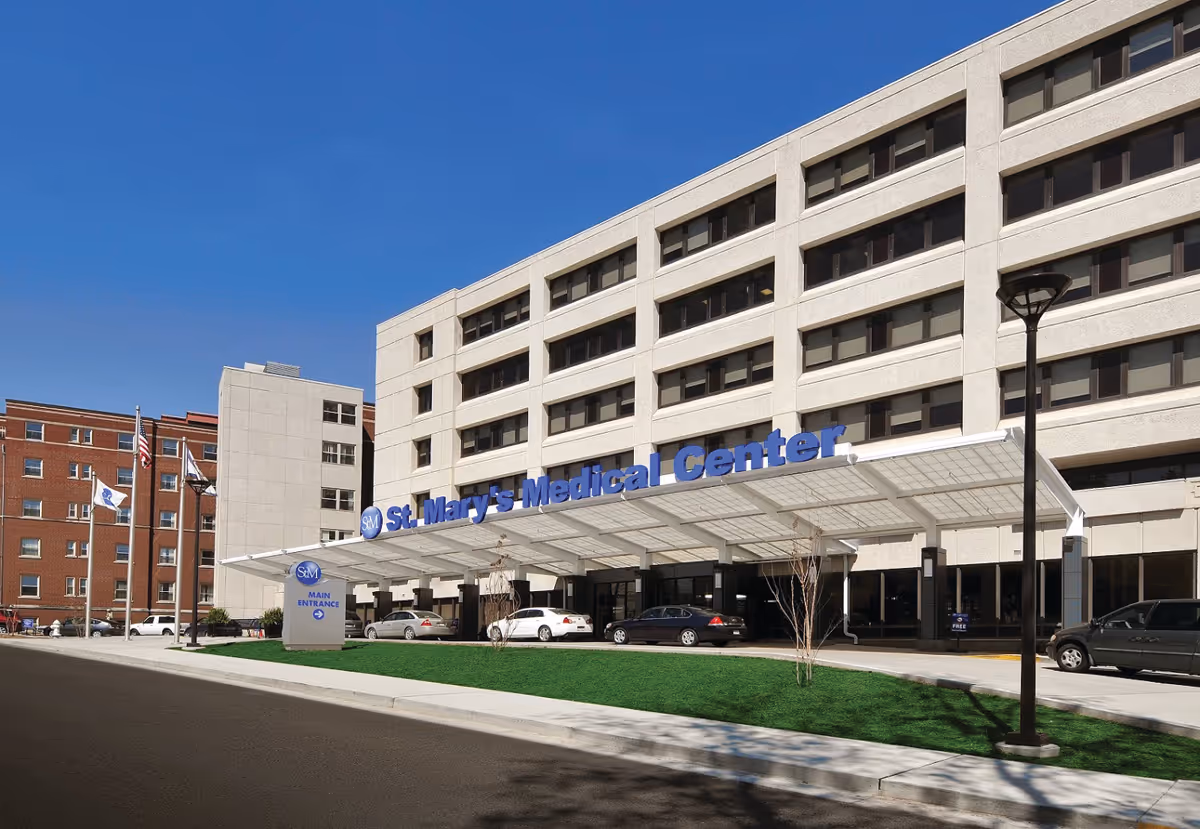 Exterior view of St. Mary's Medical Center with entrance canopy and parked cars.