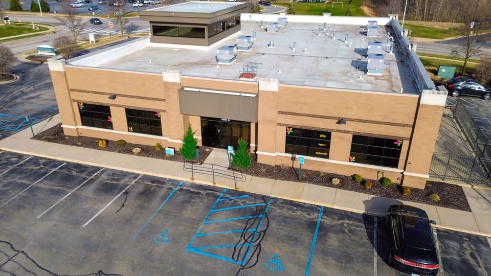 A Total Spectrum ABA brick facility viewed from above with a parking lot and entrance.