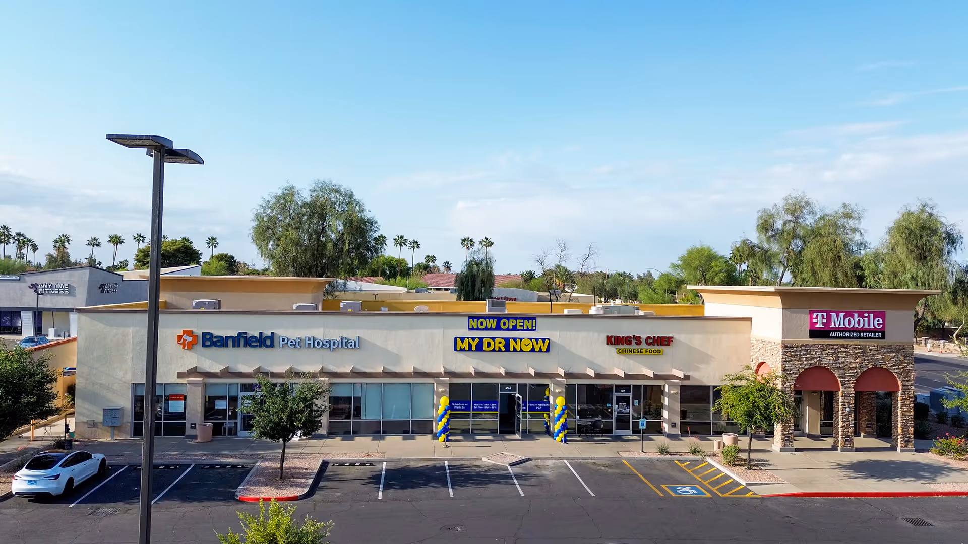 Exterior view of a strip mall front featuring MY DR NOW and other storefronts.