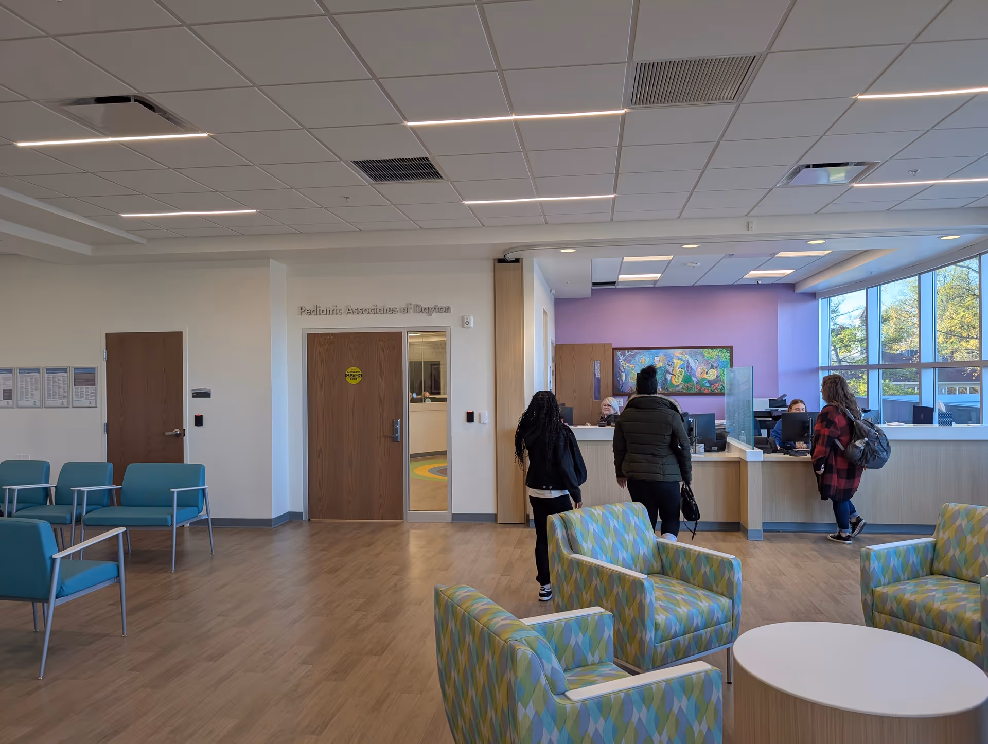 Lobby of a senior living facility with a reception desk and seating area.