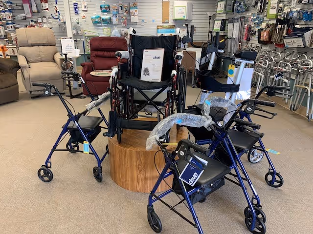 Interior showroom with walkers, wheelchairs, and other mobility aids arranged around a circular wooden pedestal.